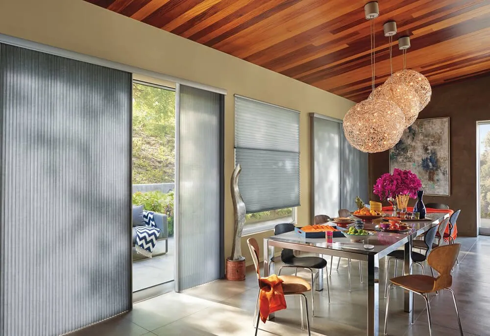 Dining room with sliding glass doors and modern blinds.