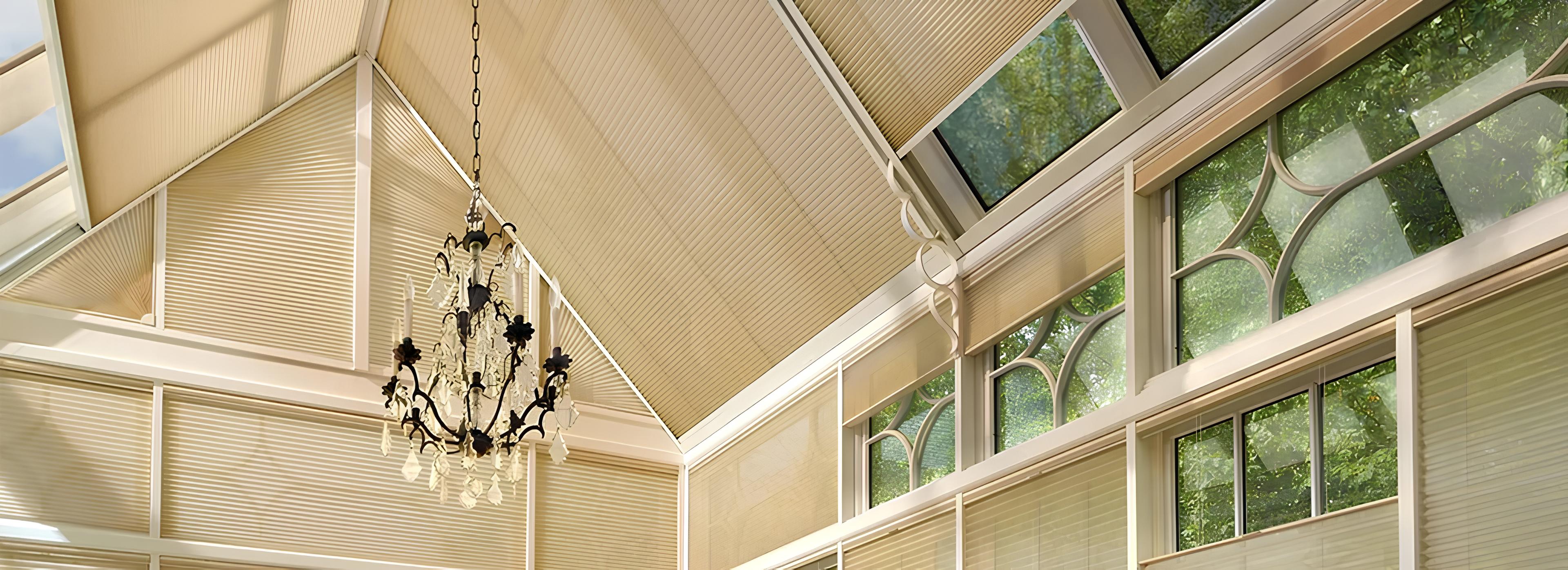 Skylight with beige shades and chandelier.