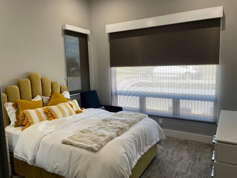 Bedroom with roller and solar screen shades