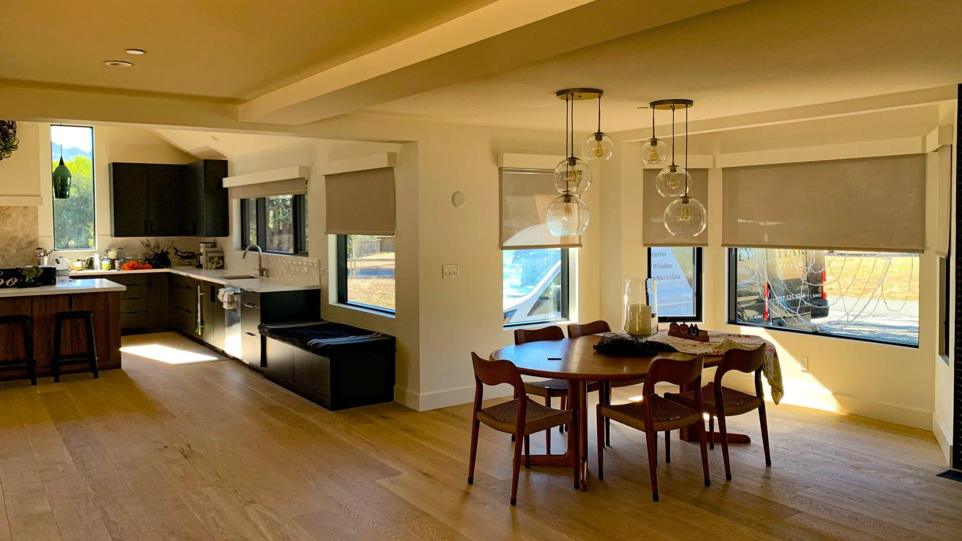 Contemporary room with motorized roller shades on floor-to-ceiling windows.
