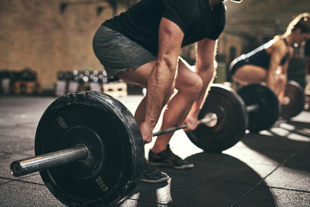 Client performing powerlifting in D.C. with an expert coach