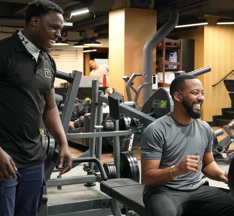 Gym goer with injury prevention personal trainer
