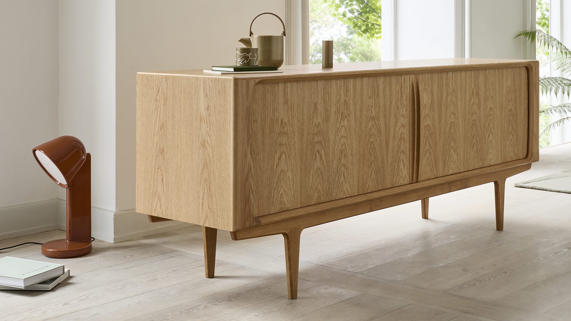 Bernh. Pedersen & Søn is a Danish furniture maker established in 1902, representing four generations of family–owned production and expert cabinetmaking. Based in Denmark, the company is renowned for its dedication to high–quality craftsmanship and sustainable production. The brand specialises in timeless furniture, with a primary focus on sideboards and pieces featuring classic tambour doors. These iconic designs are rooted in the golden age of Danish modernism, specifically the 1950s and 1960s. Today, the fourth generation continues to develop and produce furniture from the family workshop, ensuring that every piece meets the highest standards of durability and style for a global market.