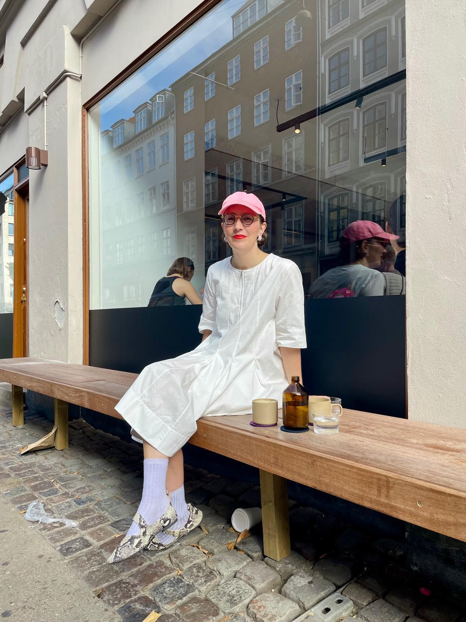 Sara Berg sitting on a bench and smiling towards the camera