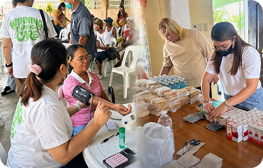 Volunteers providing free medical checkups to community members at a local medical mission
