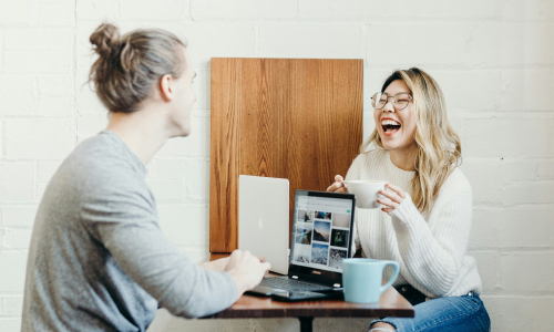 Two people sitting at table talking