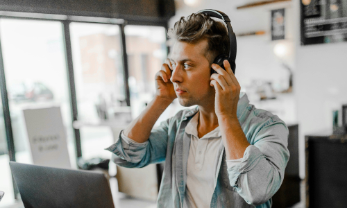 Man listening to podcast at desk