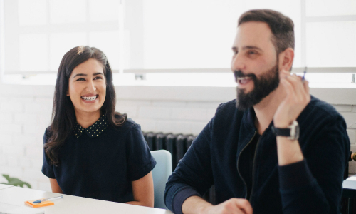 Two business people laughing