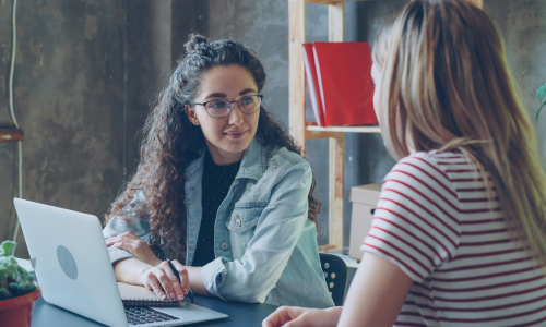 Two business women talking
