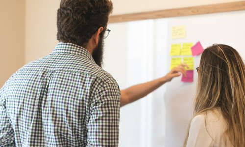 Business people at white board
