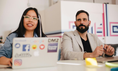 Two business people sitting at table