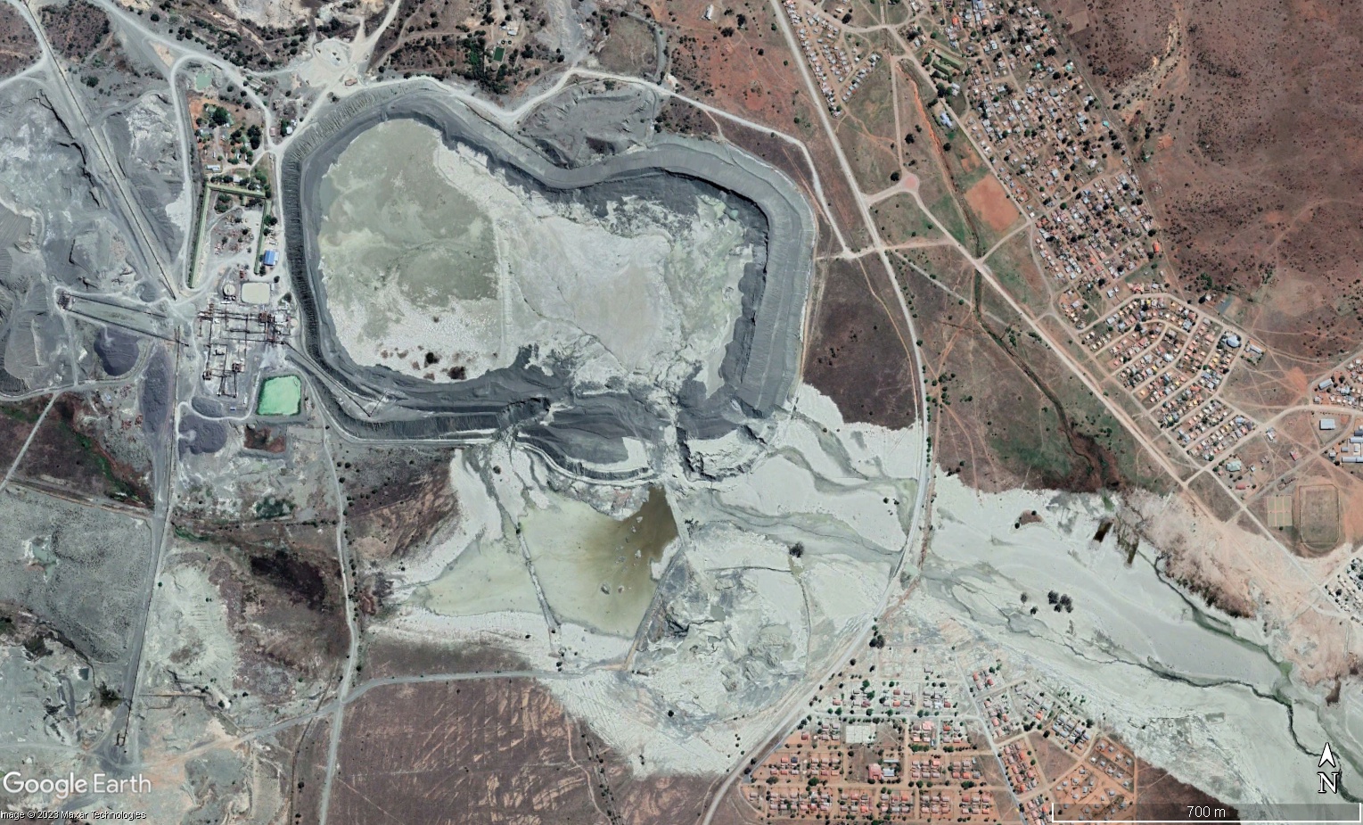 Open pit mine slope with benches and haul roads