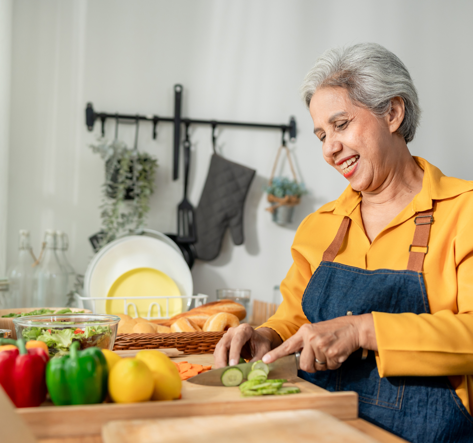 senior woman cutting vegetables