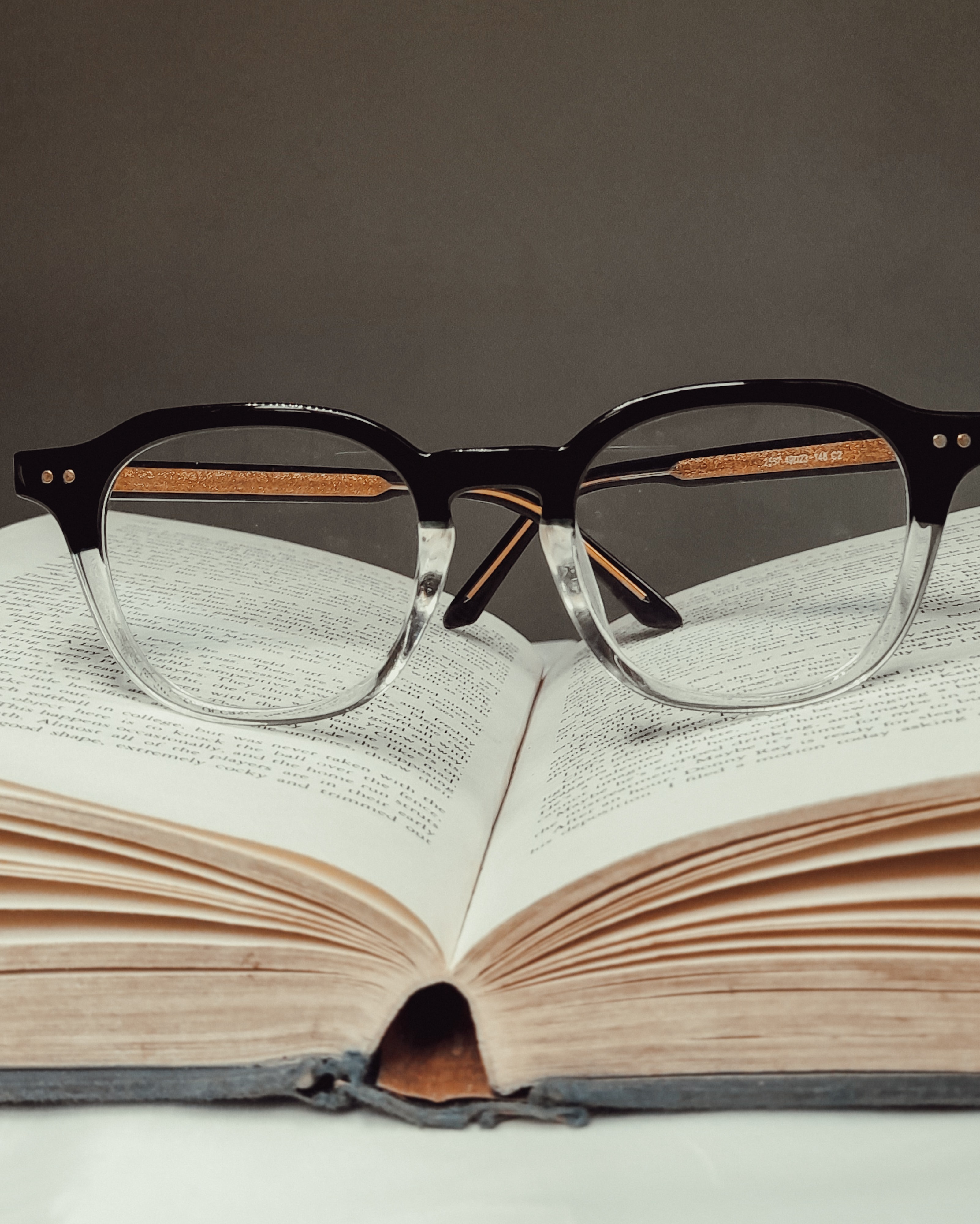 Image of glasses placed in the middle of an open dictionary