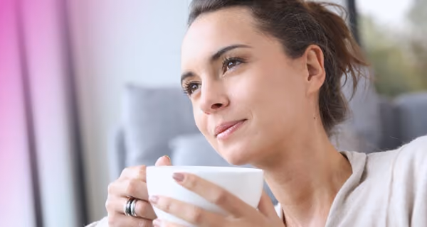 Woman sipping tea and looking relaxed