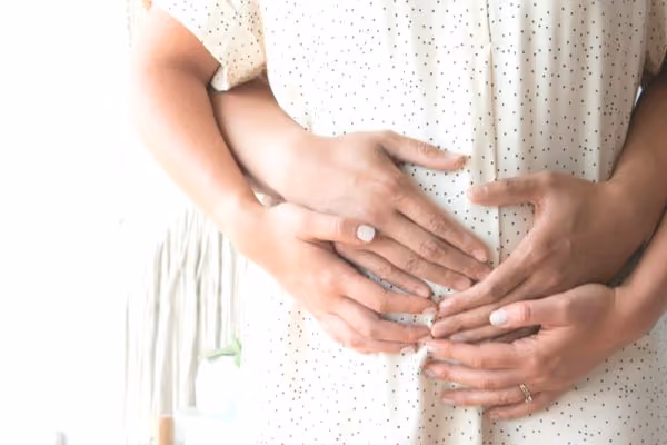 IVF success pregnant couple embracing