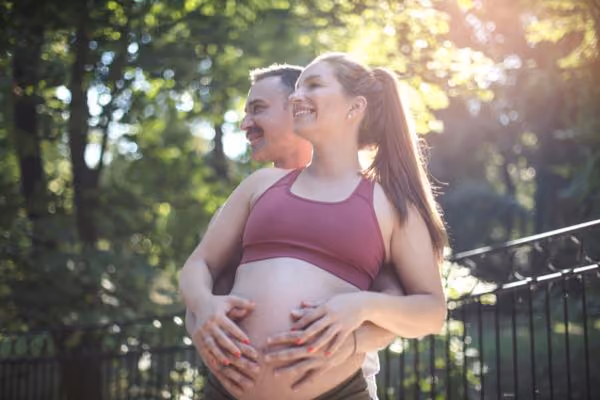 IVF success: a pregnant couple in the park