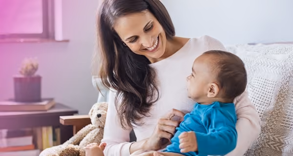 Mother enjoying with her child on her lap