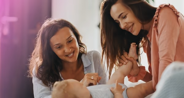 Young lesbian couple caring for their first child