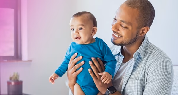 Proud fertility patient shows his child