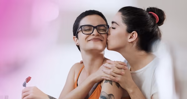 Young woman gives her partner a kiss on the cheek