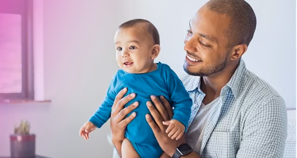 Proud fertility patient shows his child
