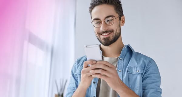 Young man reading medical test results on his mobile phone