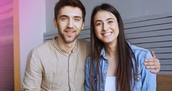 Young smiling couple in modern clinic office