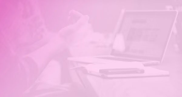 A person with a laptop at a conference table