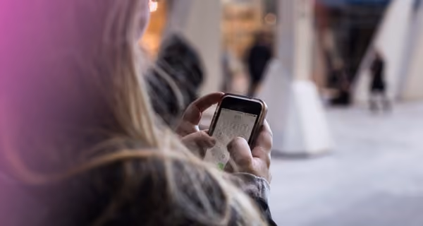 Shoulder view of woman using her mobile phone