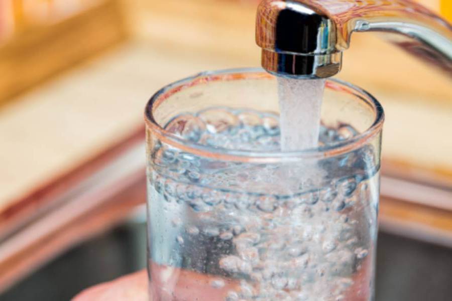 Glass being filled with tap water