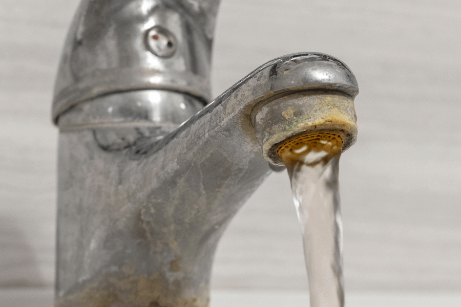 Faucet with limescale and running water