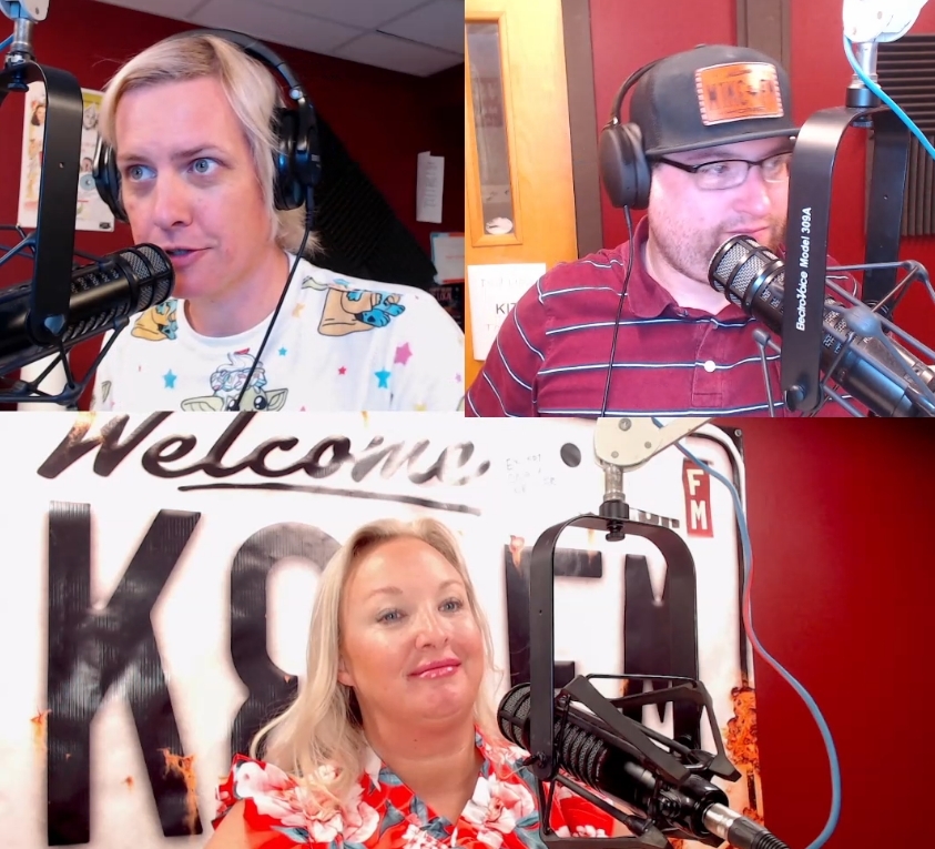 Radio hosts speaking into microphones in studio