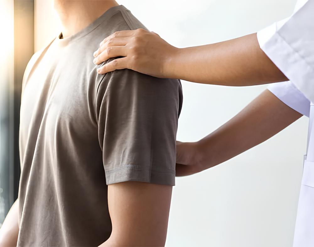 Doctor examining a patient's shoulder.