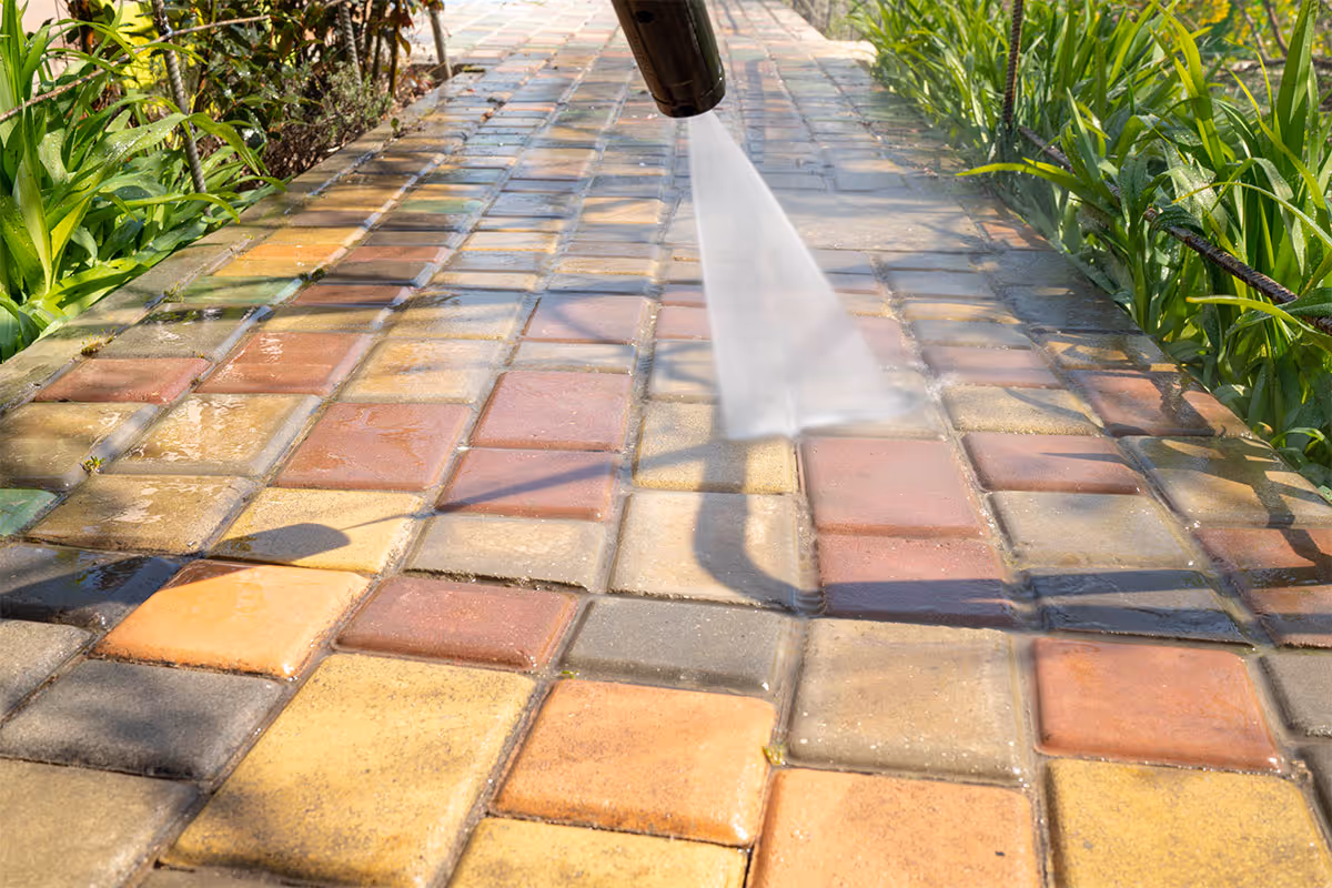 Pressure washing a sidewalk.