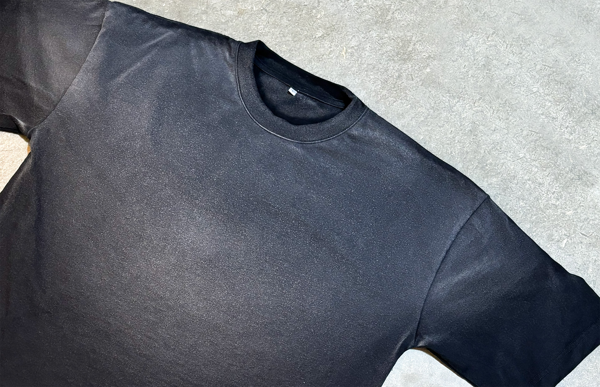 Washed black tee with a faded vintage finish