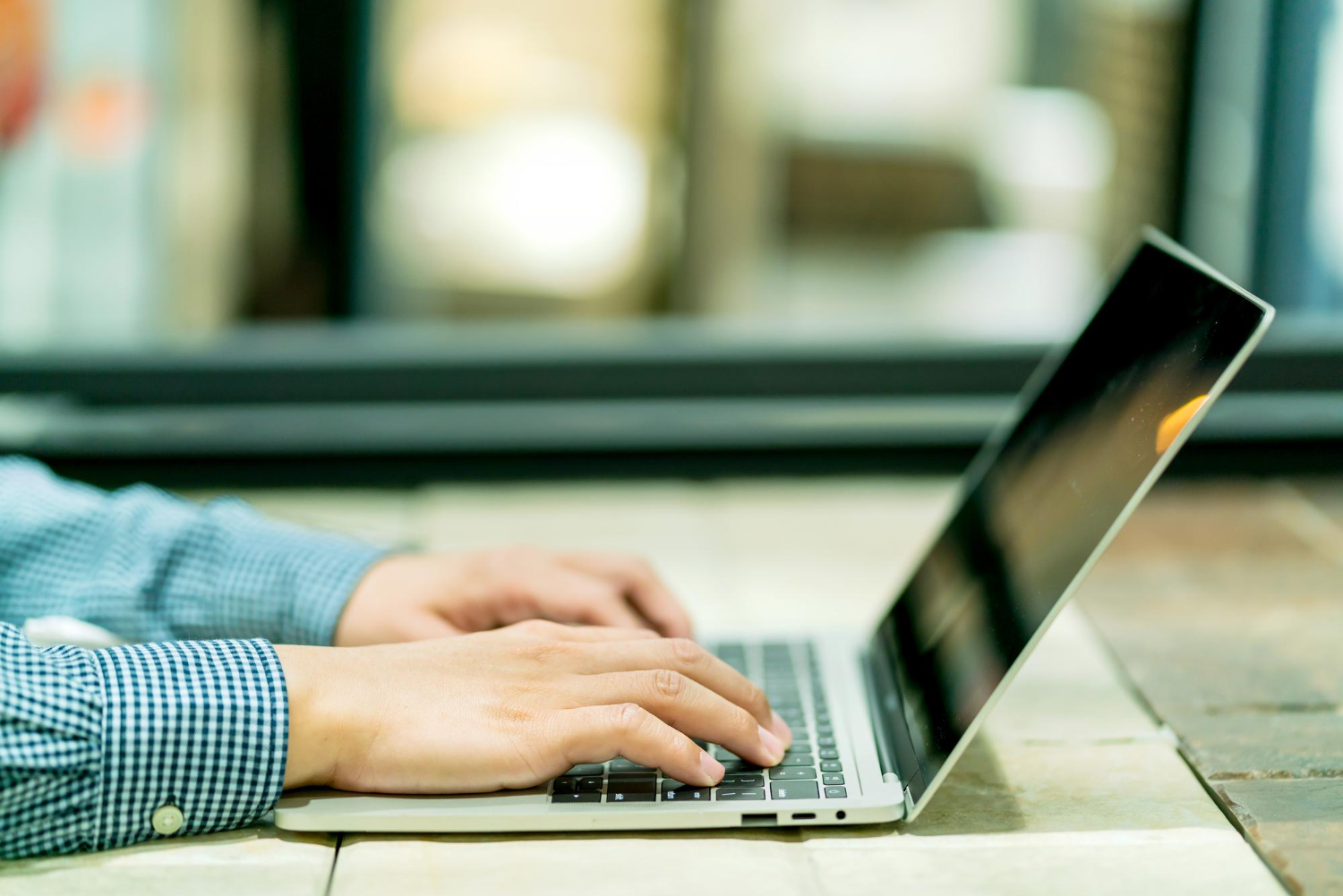 Typing a written quote on a laptop
