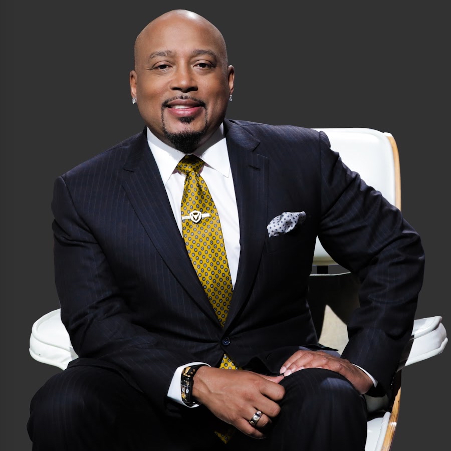 Daymond John seated on the judges panel listening to an entrepreneur