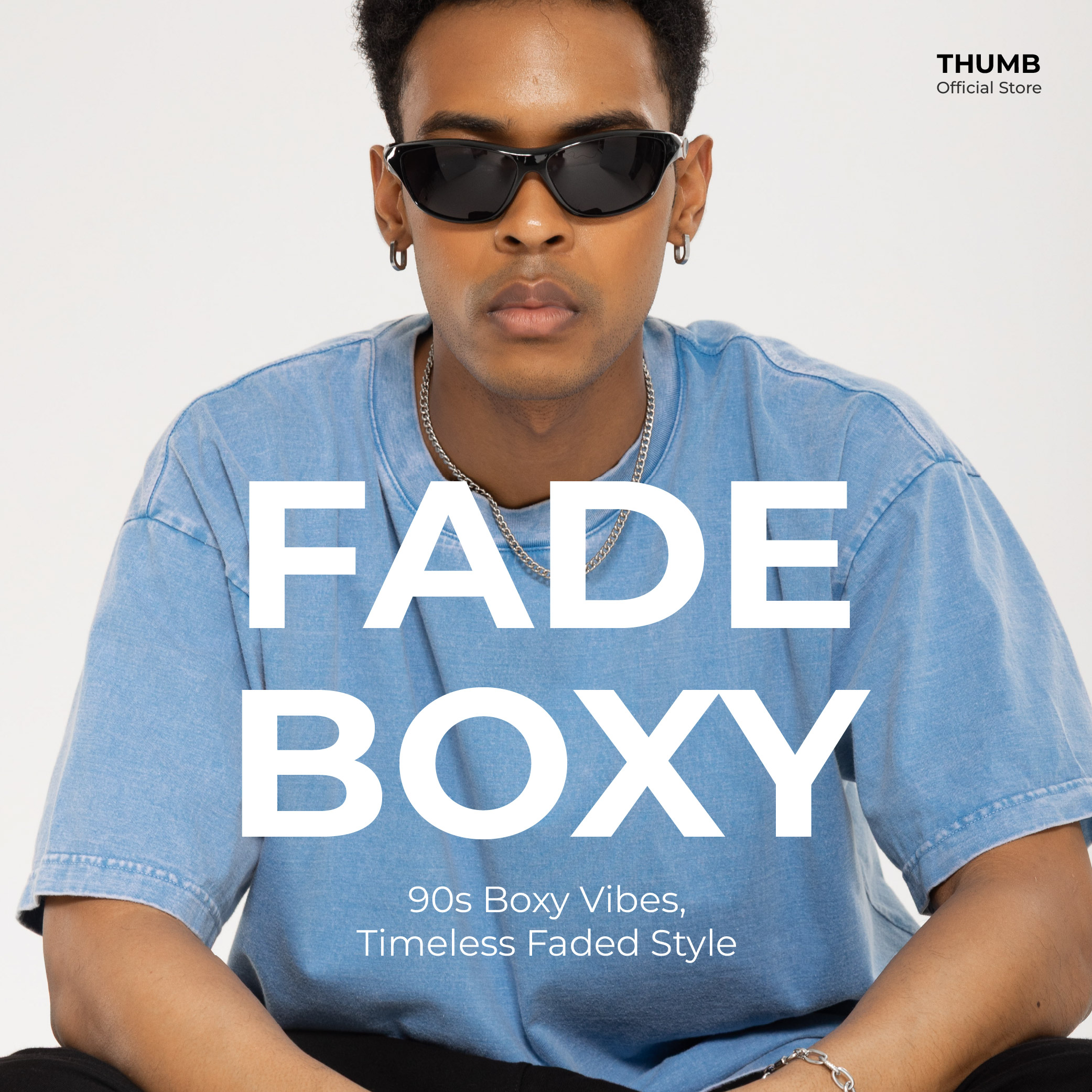 Model wearing a blue washed boxy tee with a faded finish