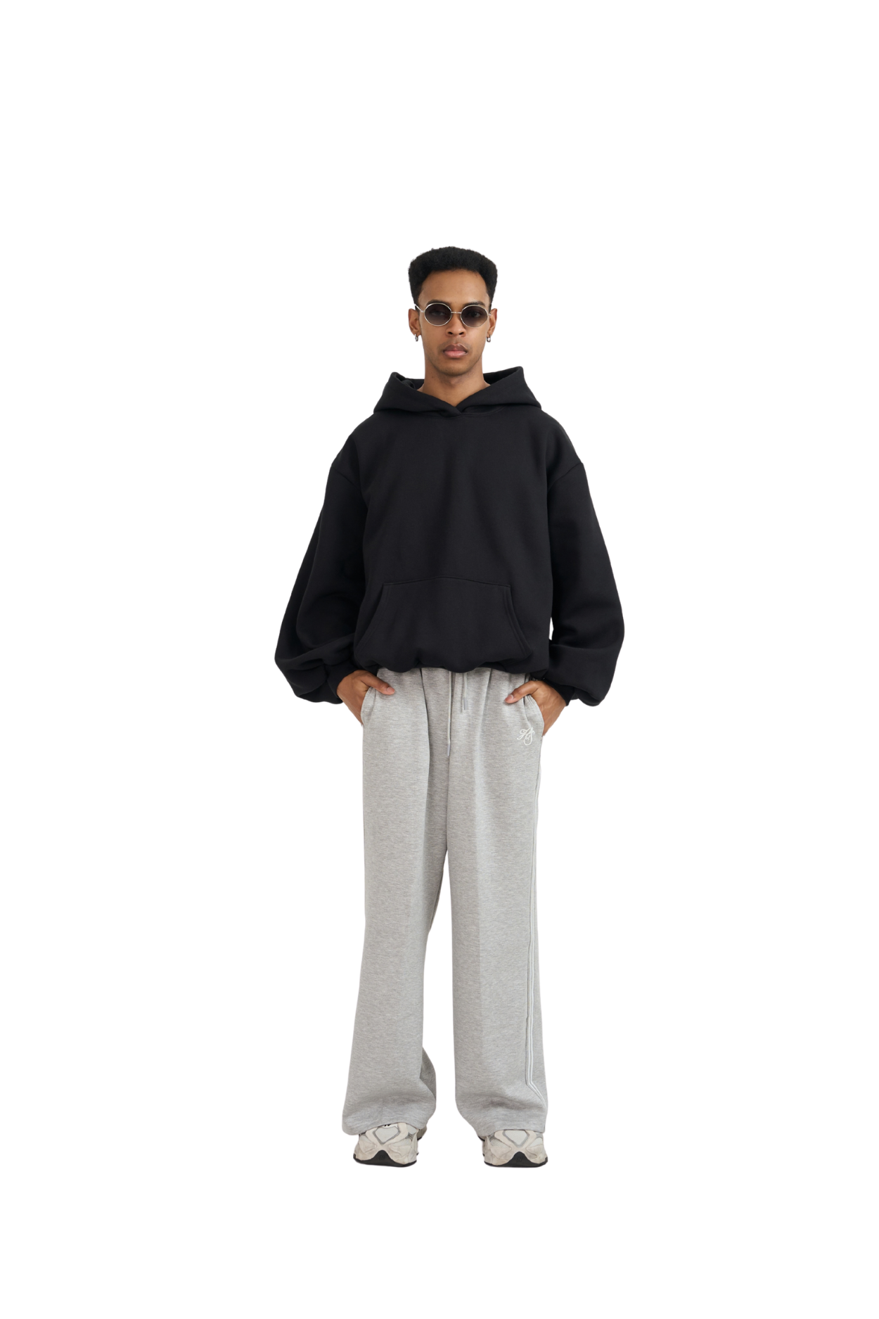 Black balloon-fit hoodie worn with grey sweatpants, full-length view