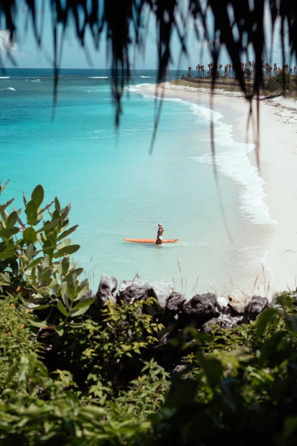 Rote Island white sand beach with surfer