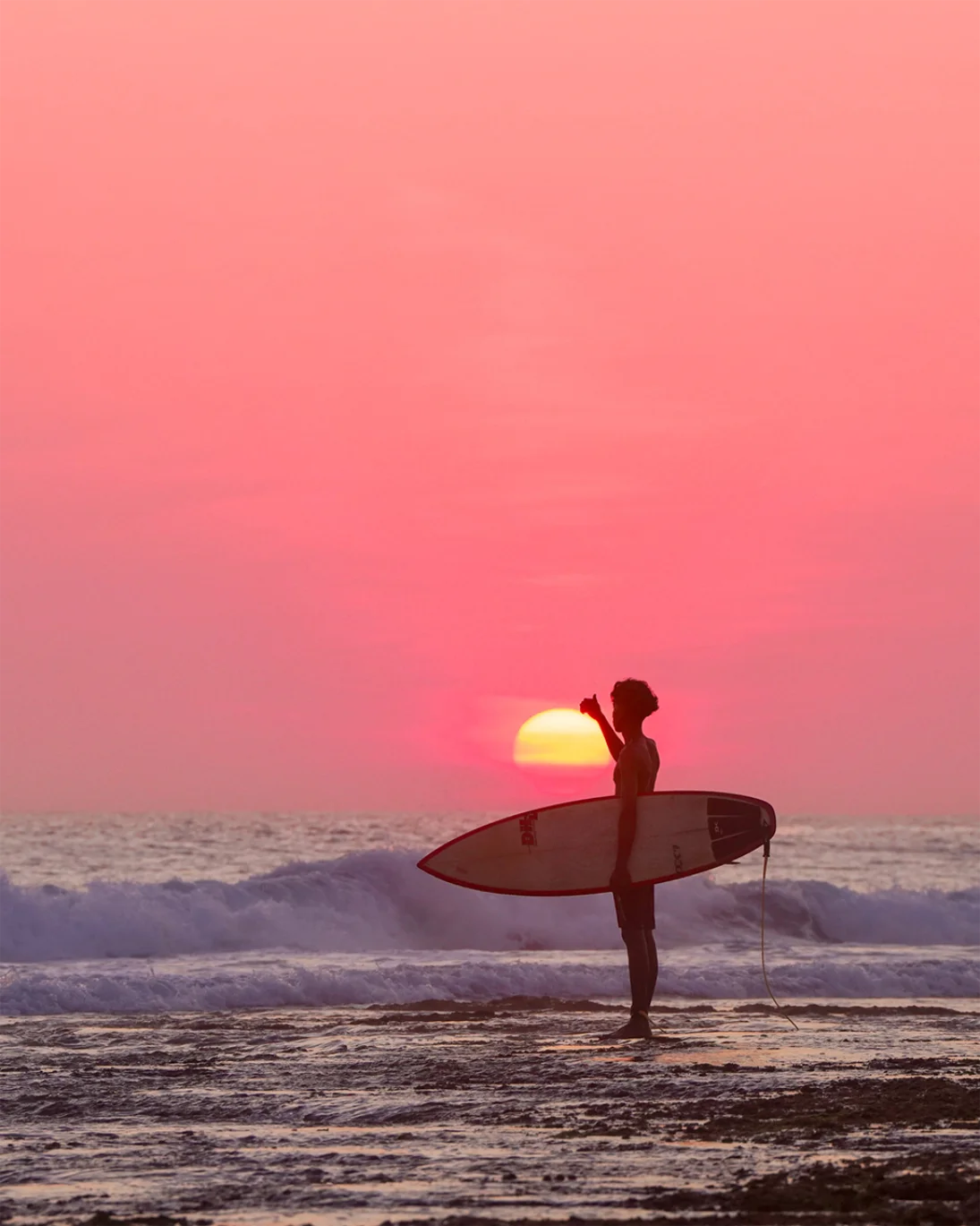 Rote island surfer and sunset