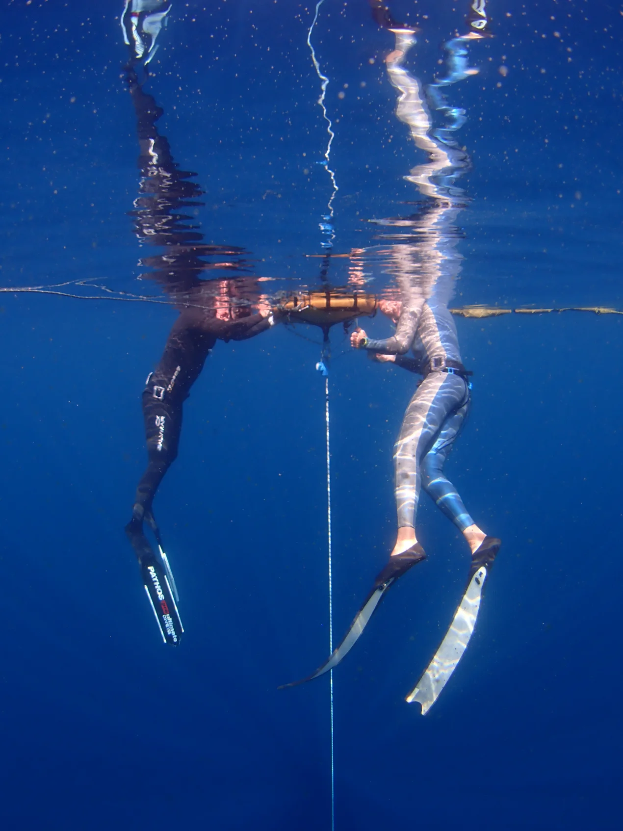 Freedivers training on a buoy in Indonesia
