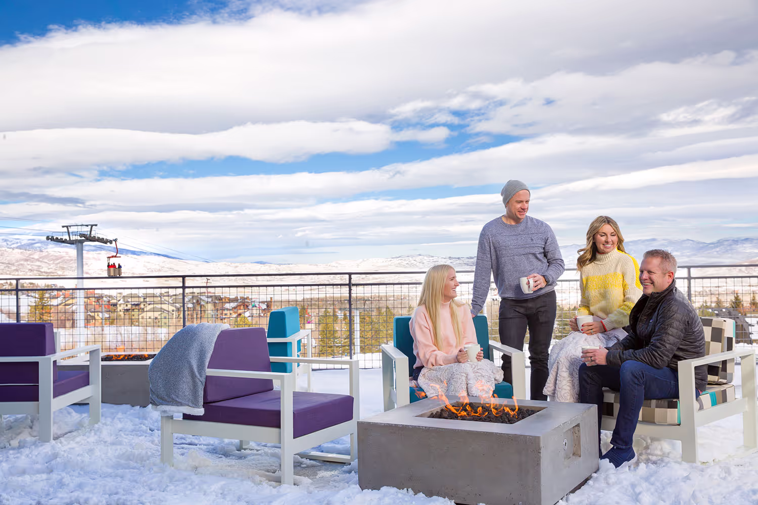 couples sitting by firepit