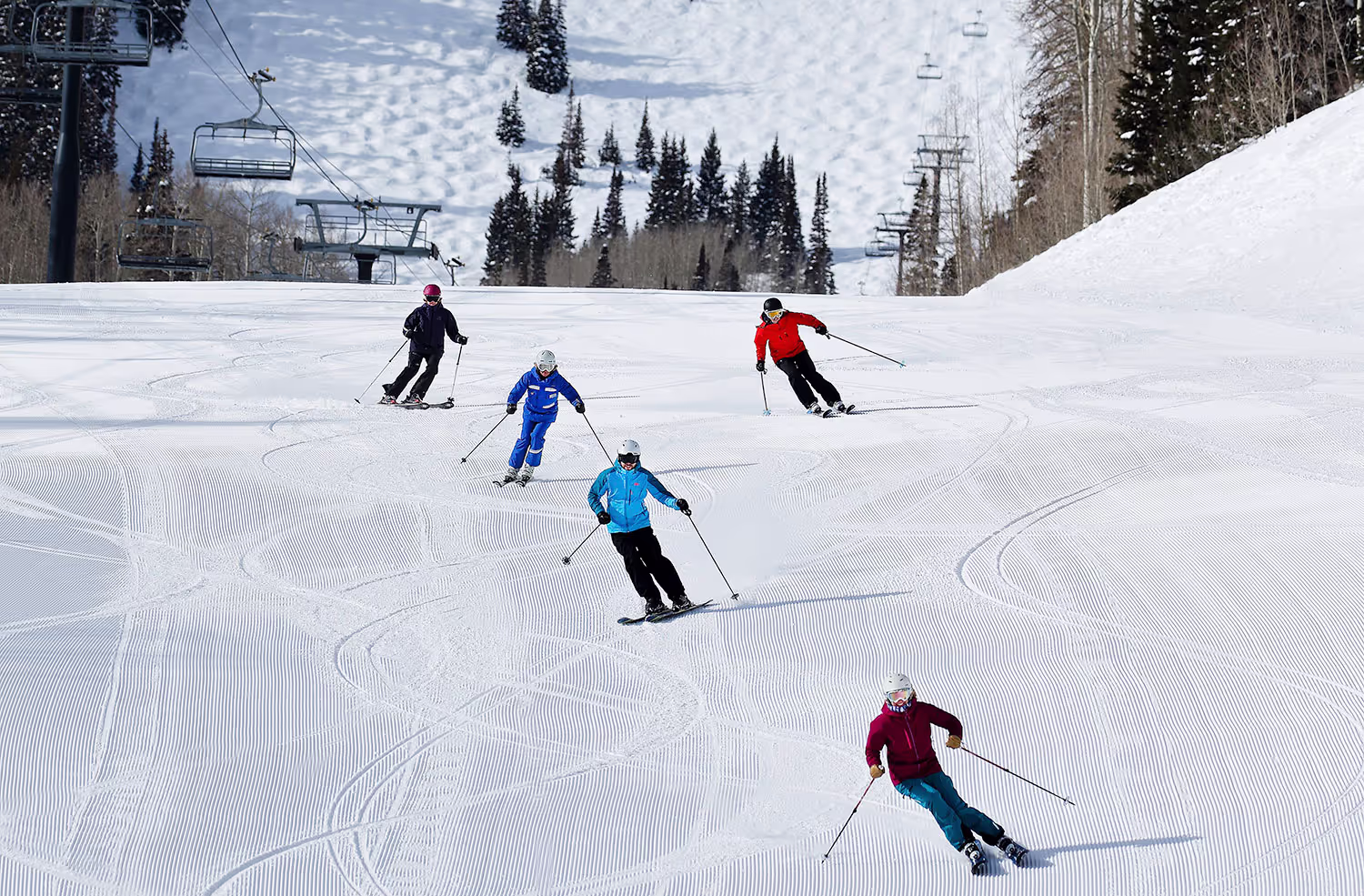 five skiers going down mtn