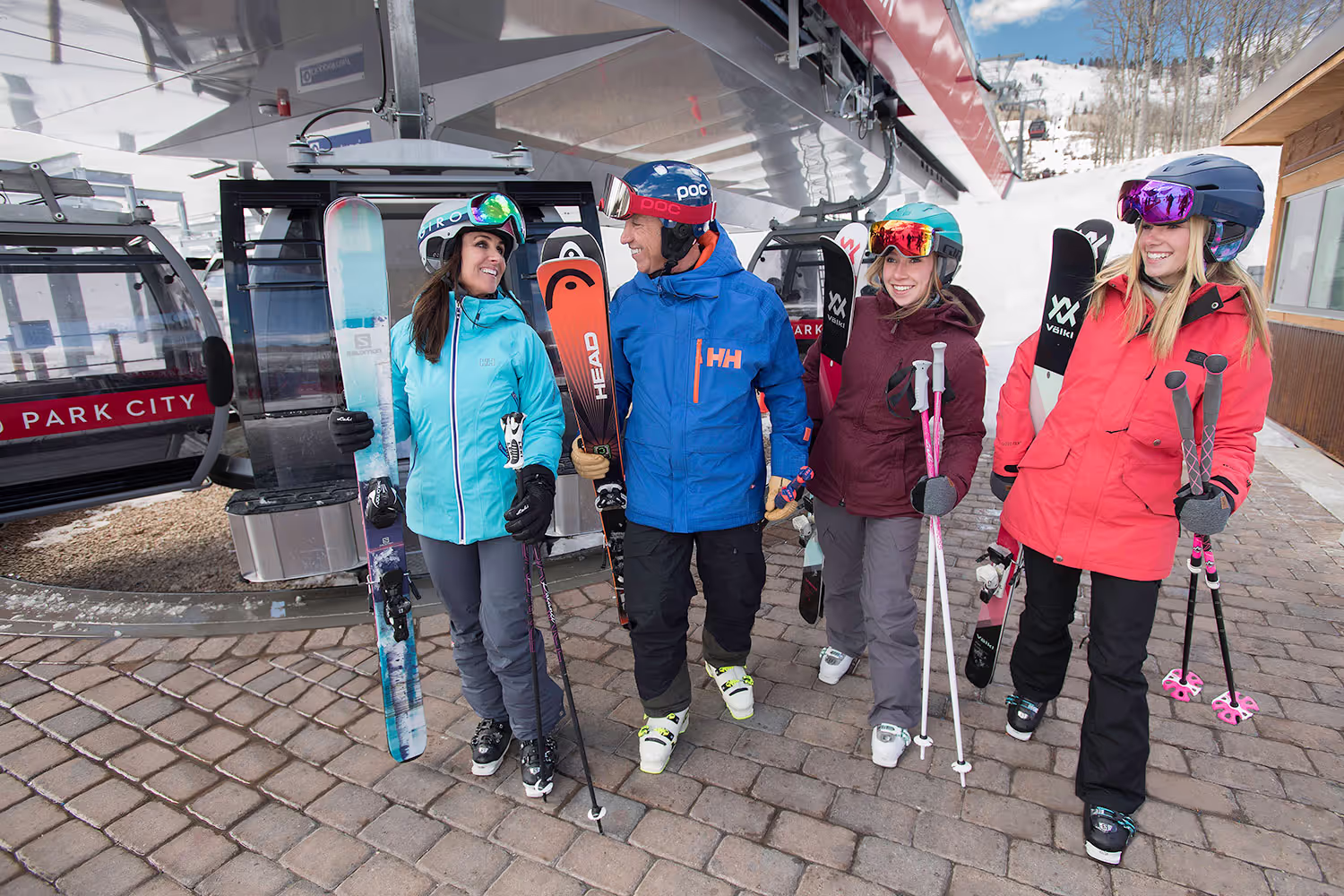 four skiers by the ski lift