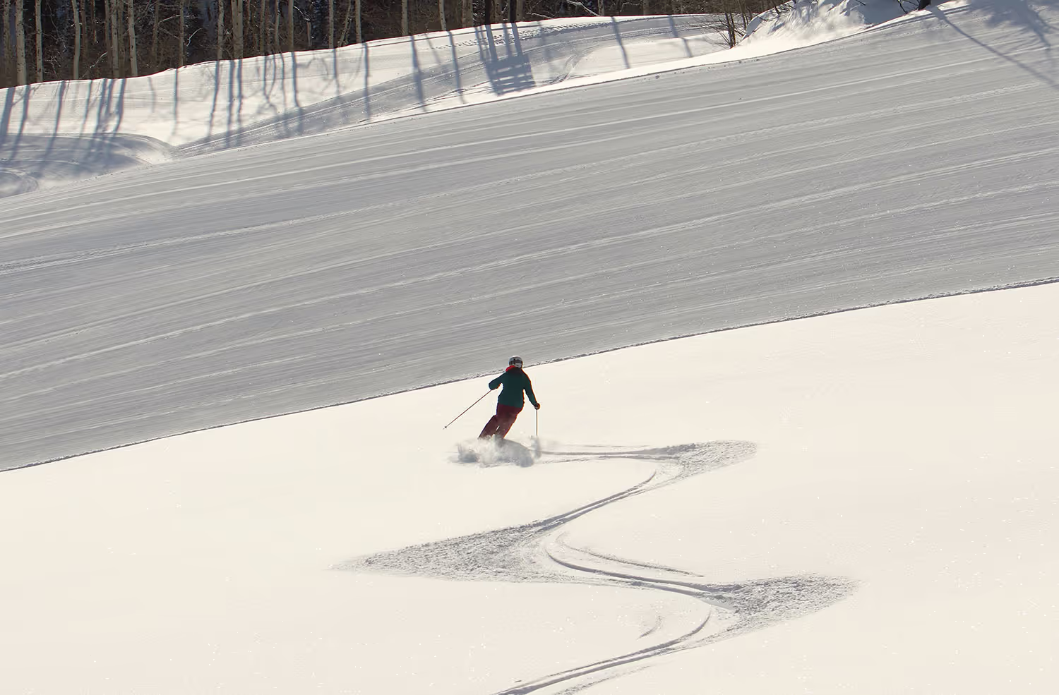 person skiing through deep snow