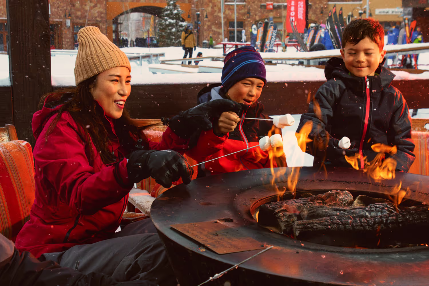 mom and children roasting marshmallows on the fire