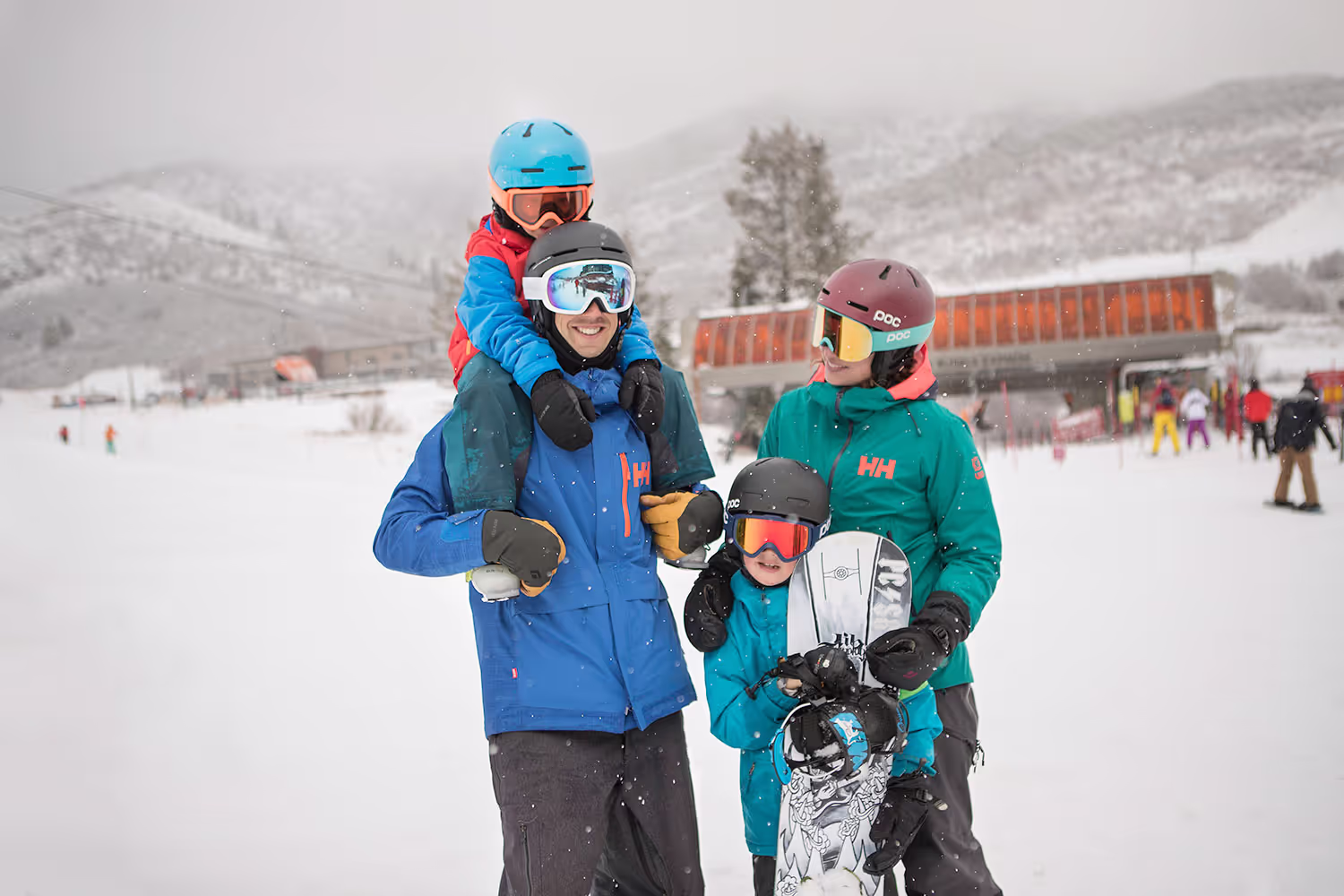 family standing in the snow