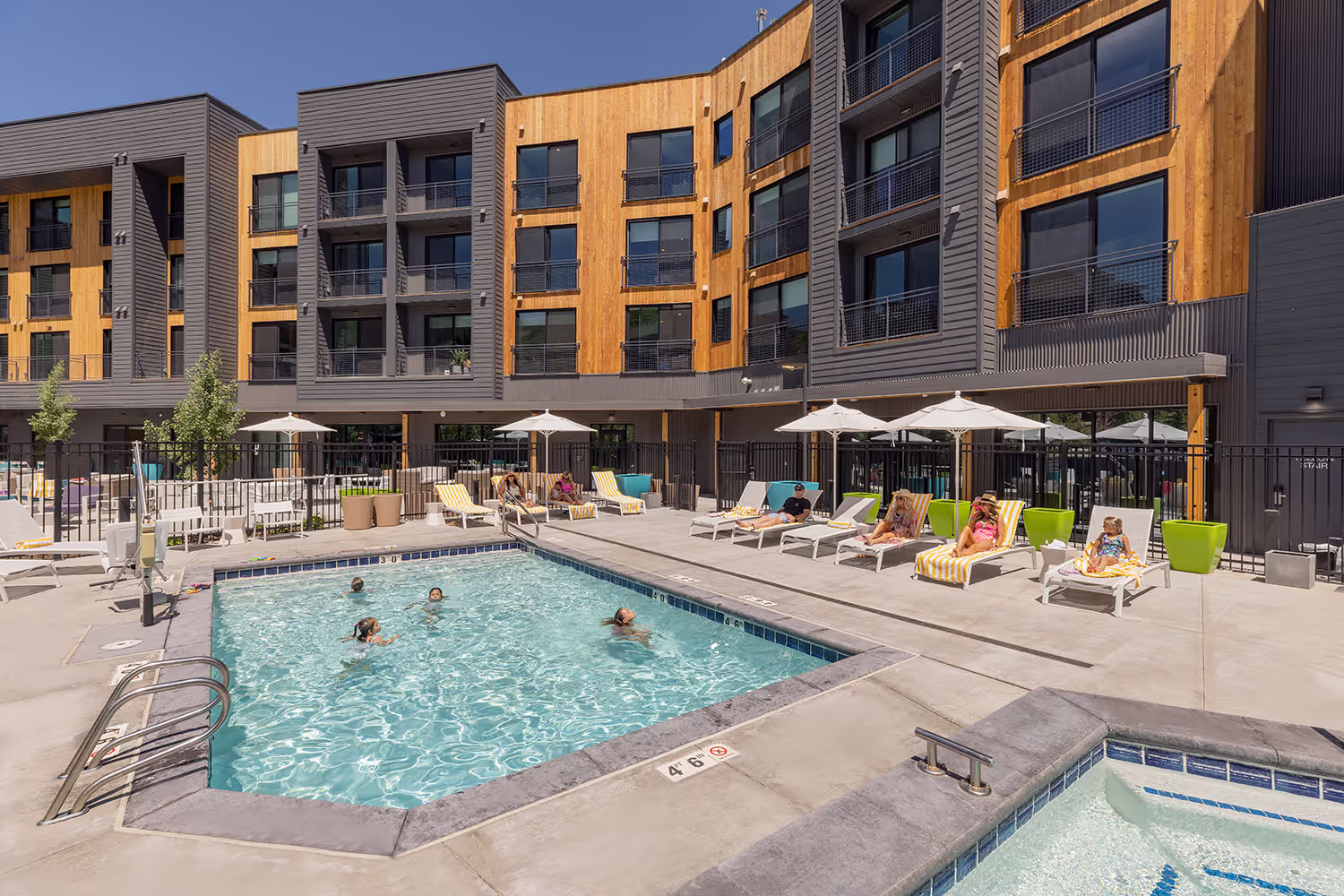 People swimming and lounging at the pool.